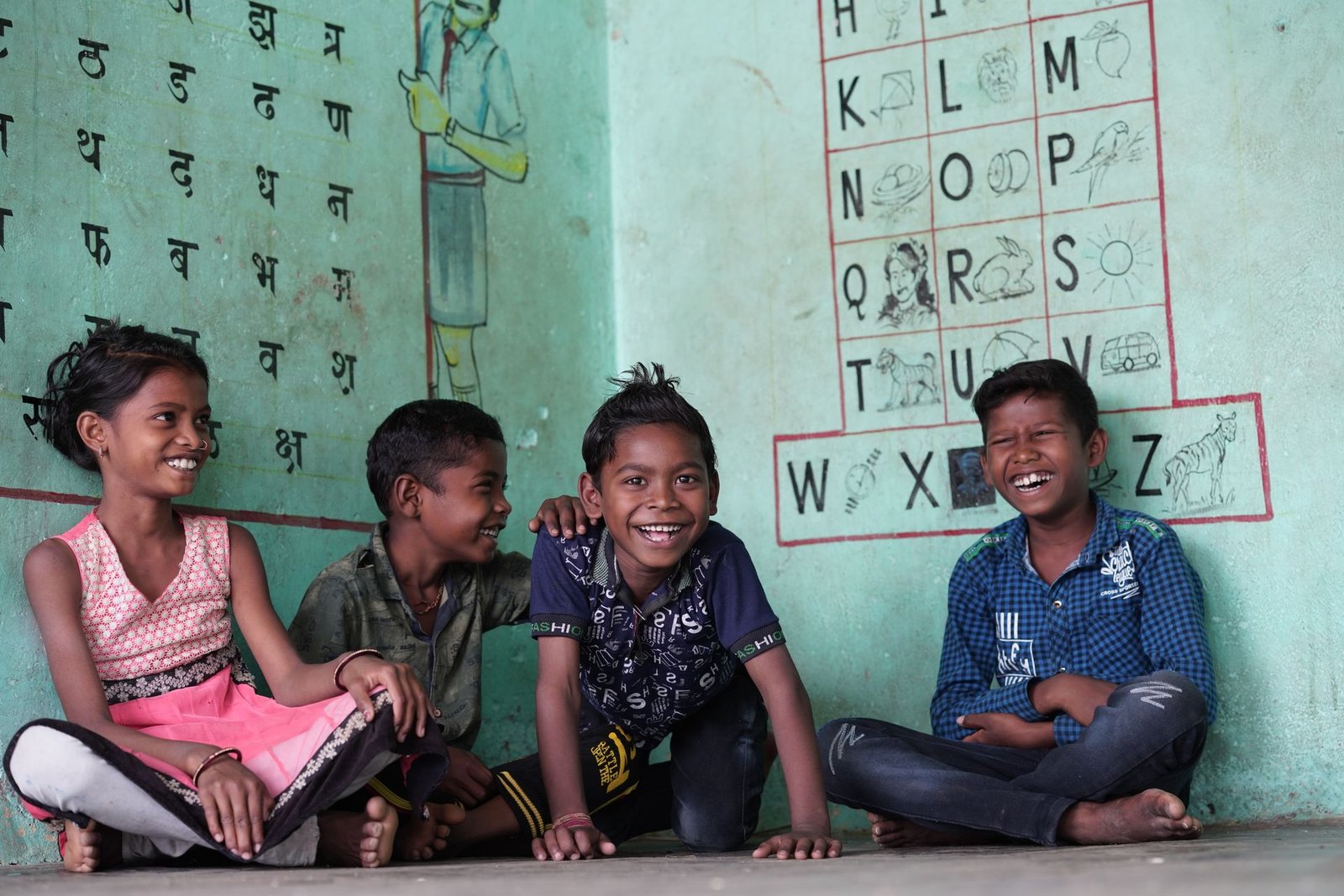 Children seated outside a classroom